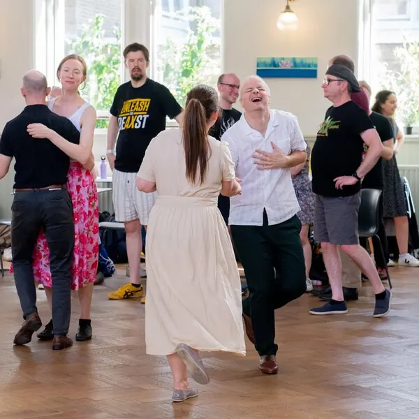 Two dancers grinning at each other